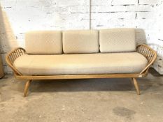 Ercol - A blonde elm 'Surfboard' day bed / sofa, with upholstered cushions, hoop and spindle arm