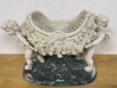 Two resin Cherubs holding a pierced basket with roses to exterior on faux marble base (32cm x 47cm x