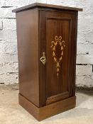 An Edwardian mahogany bedside cupboard, the panelled door with hair bell inlay enclosing a shelf,