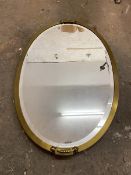 A modern oval wall mirror with bevelled edge within a gilt frame (70cm x 46cm)