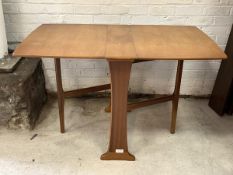 A Vintage mid century teak double drop leaf dining table, the shaped rectangular top on two gate