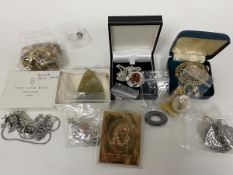 A collection of costume and silver jewellery including rings, brooches, pendants, a 22ct stamp