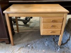 A Modern polished pine writing desk, fitted with three drawers, raised on square section supports