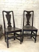 A Pair of early 19th century country oak chairs, with shaped crest rail over figural carved splat,