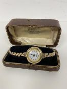 A lady's wristwatch, case marked 375, the dial inscribed IMSHI, with a rolled gold strap with