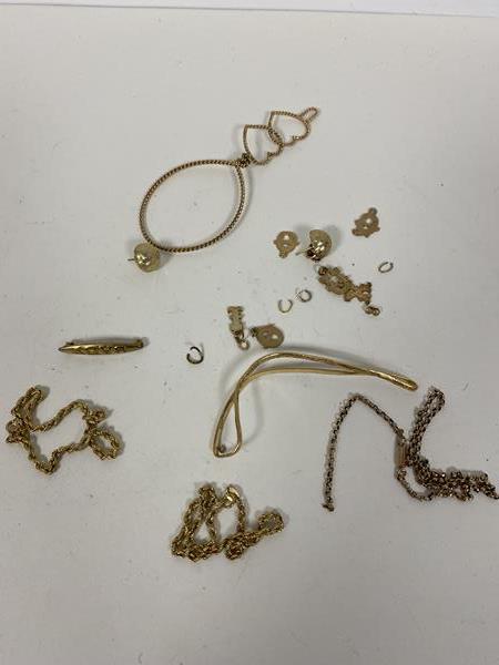 A mixed lot of scrap gold and yellow metal, including three 9ct gold chains, and a brooch