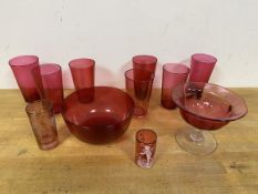 A collection of cranberry glass including a Margery Clinton style miniature mug with Boy with Net (