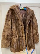 A fur jacket with two pockets to sides (32cm across shoulders x 72cm length)