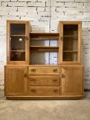 Ercol - A blonde elm sideboard, the top fitted with two glazed cabinets with illuminated interiors