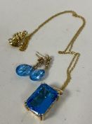A gold-plated on silver trace link chain with blue stone pendant, mount marked 585 14k