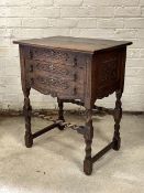 An 18th century style carved oak side table, fitted with three drawers, raised on spiral turned