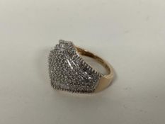 A 9ct gold dress ring with multiple chip diamonds created navette shape surrounded by diamonds (