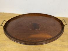An Edwardian oval drinks tray, with raised edge and brass handles (37cm x 56cm)