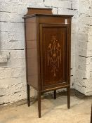 An Edwardian inlaid mahogany sheet music cabinet, with raised back panelled door enclosing three