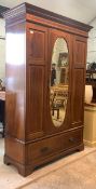 An Edwardian inlaid mahogany wardrobe, the frieze with satinwood banding over door with oval