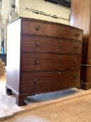 An early 19th century mahogany bow front chest, fitted with four long graduated drawers, raised on