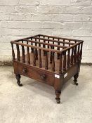 A mid Victorian walnut Canterbury, the top with two divisions on a spindle gallery above a drawer,