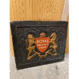 An ebonised wooden panel bearing the coat of arms for the Royal Insurance Group (47cm x 55cm)