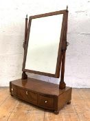 A late George III mahogany toilet mirror, the rectangular plate within a conforming ebony strung