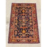 A hand-knotted Iranian Hamadan rug, the deep blue field with geometric design enclosed by a