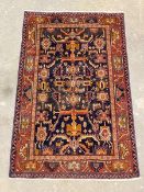 A hand-knotted Iranian Hamadan rug, the deep blue field with geometric design enclosed by a