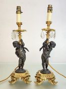 A pair of gilt and patinated metal figural table lamps, in 18th century style, each with a shaped