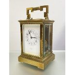 A brass repeating alarm carriage clock, early 20th century, the eight day twin-train movement with