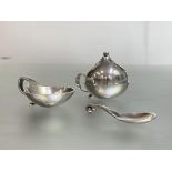 Georg Jensen: a sterling silver salt and spoon and a pepperette, the salt and spoon stamped Sterling