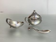 Georg Jensen: a sterling silver salt and spoon and a pepperette, the salt and spoon stamped Sterling