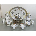 An extensive Herend "Queen Victoria" porcelain coffee service, decorated with butterflies and floral