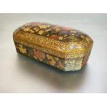 A 19th century Persian floral lacquer box, of oblong form, with canted corners, the domed lift-off