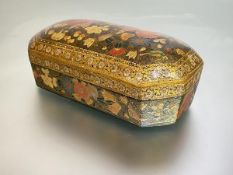 A 19th century Persian floral lacquer box, of oblong form, with canted corners, the domed lift-off