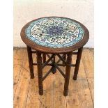 A late Victorian Aesthetic period occasional table, the circular top inset with tiles of Iznik