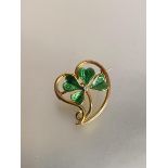 A diamond-set enamelled yellow metal brooch modelled as a shamrock, centred by a round brilliant-cut