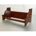 An Edwardian mahogany book trough, the shaped panel end supports with satinwood bands and boxwood