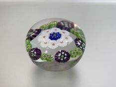 A miniature millefiori paperweight, possibly Clichy, with concentric rings of multi-coloured