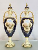 A pair of tall Coalport porcelain vases and covers, c. 1900, each painted to one side with a named