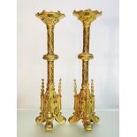 A handsome pair of gilt-metal Gothic Revival candlesticks, 19th century, each candle socket within a
