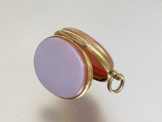 A late 19th century white chalcedony locket, oval, unengraved, mounted in unmarked yellow metal, the