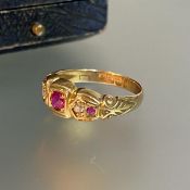 A five stone ruby and diamond ring, the central round-cut ruby flanked by pairs of diamond and