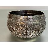 A Thai silver centre bowl, unmarked, elaborately chased with figural cartouches, scrolls and