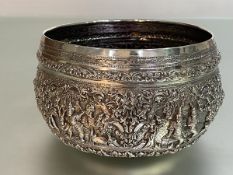 A Thai silver centre bowl, unmarked, elaborately chased with figural cartouches, scrolls and