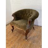 A Victorian mahogany tub chair, upholstered in green buttoned velvet, with scrolled arm terminals