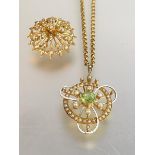 An Edwardian 15ct gold peridot and seed pearl pendant, further decorated with white enamel (losses