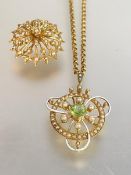 An Edwardian 15ct gold peridot and seed pearl pendant, further decorated with white enamel (losses