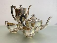 A composed Edwardian silver four piece tea and coffee service, the coffee pot, teapot and cream