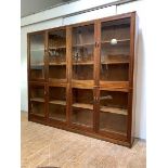 A mahogany glazed bookcase, mid-20th century, fitted with eight glazed doors, enclosing six