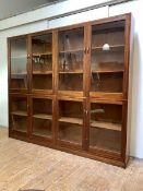 A mahogany glazed bookcase, mid-20th century, fitted with eight glazed doors, enclosing six