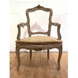 A French parcel-gilt fauteuil, 19th century, the acanthus-carved crest rail over a scrolled back and