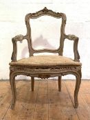 A French parcel-gilt fauteuil, 19th century, the acanthus-carved crest rail over a scrolled back and
